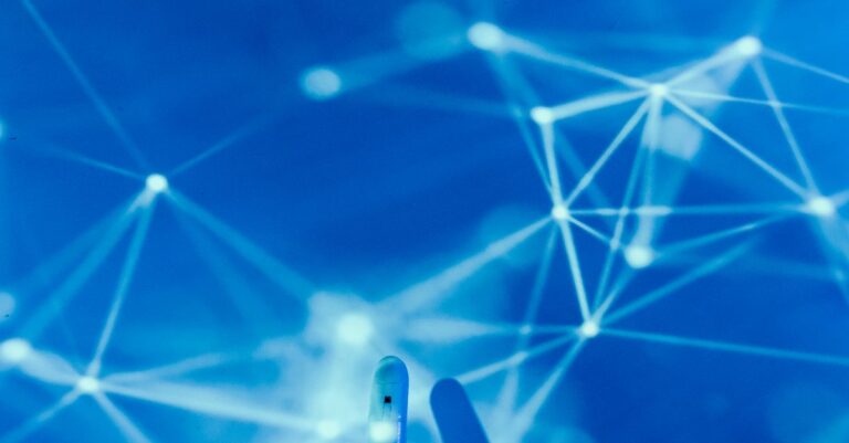 Futuristic robotic hand touching a digital network on a blue background.